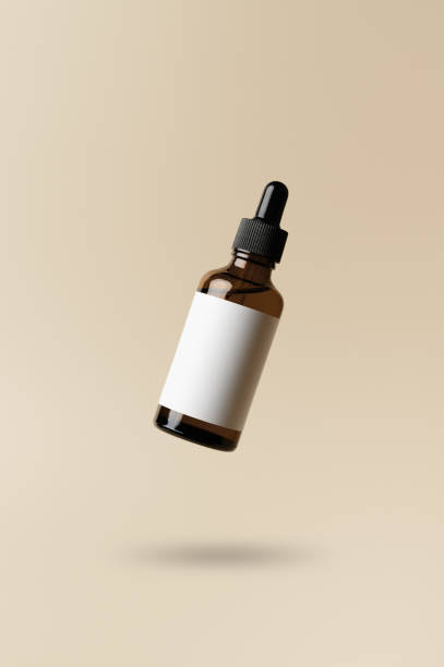 Brown dropper glass bottle flying in antigravity on pastel beige background. Levitation object in the air. Skincare concept. Organic natural cosmetic product. Mockup, minimal style stock photo