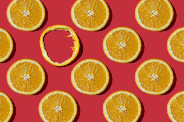 istock Summer composition made from oranges, on dark red  background. Creative Pattern made of slices of orange. Flat lay, top view of colorful fruit pattern of fresh orange slices on orange colorful background. 1369797793