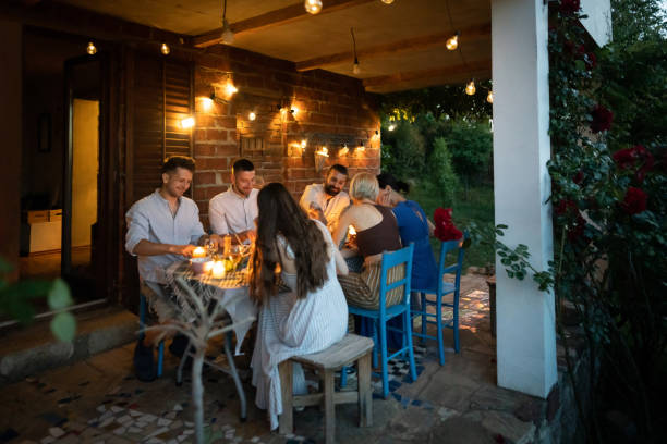 istock Joyful couples enjoying the dinner party in the garden 1369799304