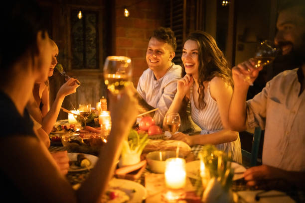 istock Joyful couples enjoying the dinner party in the garden 1369800370