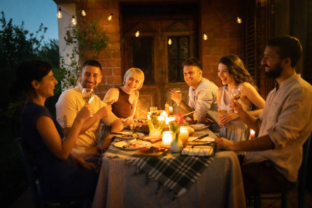istock Joyful couples enjoying the dinner party in the garden 1369800392