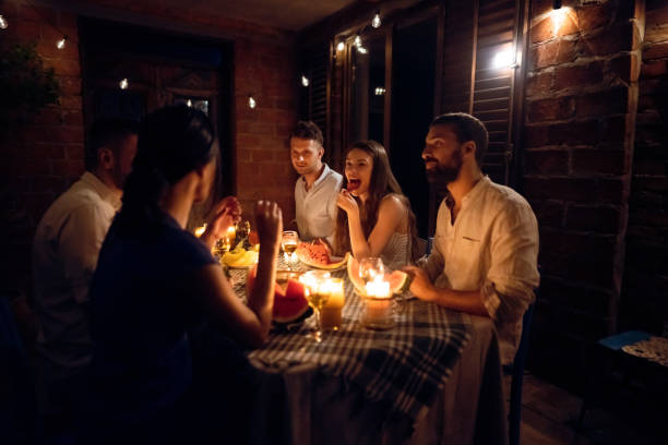 istock Joyful couples having a serene time together during dinner party 1369801314
