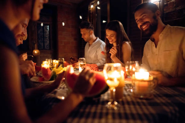 istock During summer night, serene friends enjoy romantic dinner 1369801371