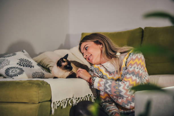 istock Beautiful girl and her Siamese cat 1369801444