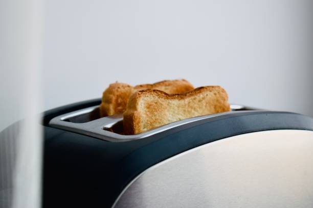 istock Baked toast in a toaster on a white background, breakfast 1369802081