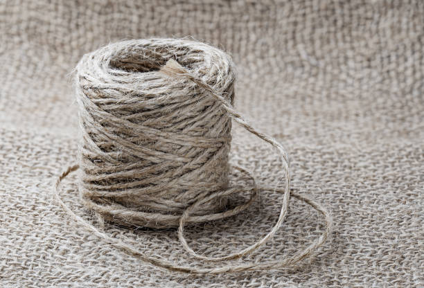 istock A roll of natural jute twine on a burlap background. 1369802510