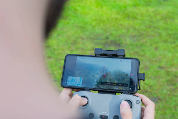 istock Man drives drone from above watching it from the screen 1369803925