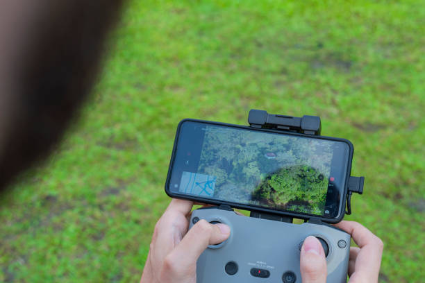 istock Man drives drone from above watching it from the screen 1369803967