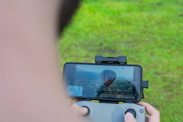 istock Man drives drone from above watching it from the screen 1369804089