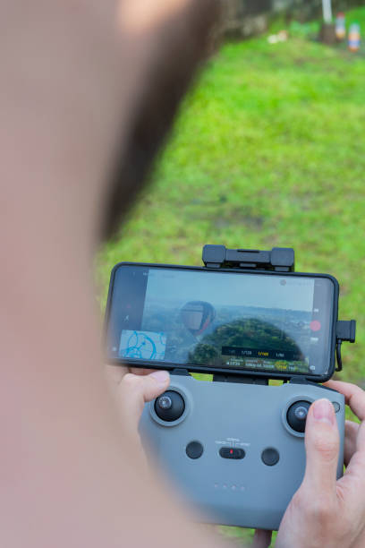 istock Man drives drone from above watching it from the screen 1369804179