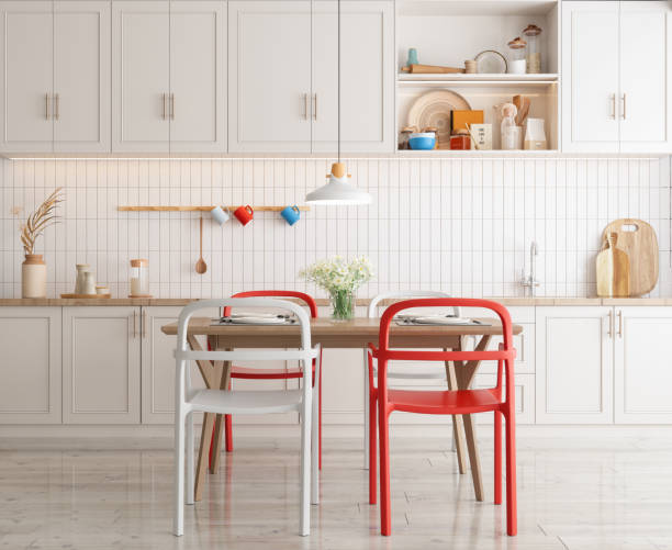 Domestic Kitchen Interior With Dining Table, Red And White Chairs, White Cabinets And Kitchen Utensils. Domestic Kitchen Interior With Dining Table, Red And White Chairs, White Cabinets And Kitchen Utensils. red kitchen cabinets stock pictures, royalty-free photos & images