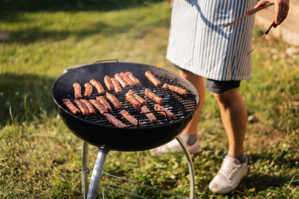 istock Unrecognizable men preparing the beef mea on the BBQ in the garden 1369805073