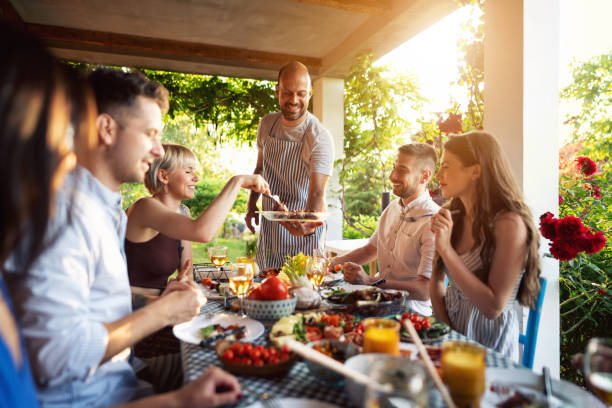 istock A chef, serving to his friends a BBQ, during summer brunch 1369806441