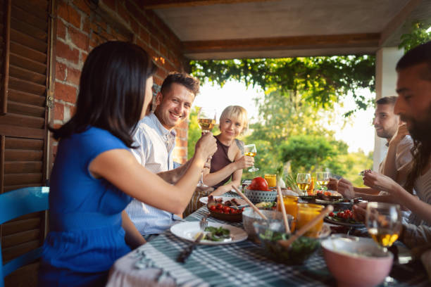 istock During garden brunch, cheerful frends toasting with alcohol 1369806461