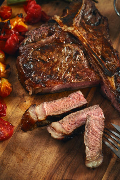istock Grilled T-Bone Steak with Asparagus, Tomatoes and Mushrooms 1369808912