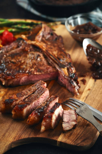 istock Grilled T-Bone Steak with Asparagus, Tomatoes and Mushrooms 1369808944