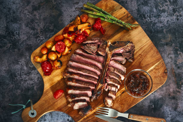 istock Grilled T-Bone Steak with Asparagus, Tomatoes and Mushrooms 1369809032