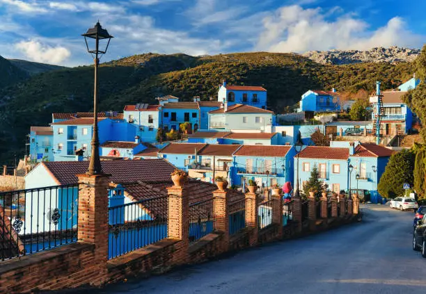 Picturesque hillside famous Juzcar town or Smurfs Village, all residential houses painted blue color. Landmarks and travel destination. Valle del Genal, Serrania de Ronda, Malaga. Andalusia, Spain