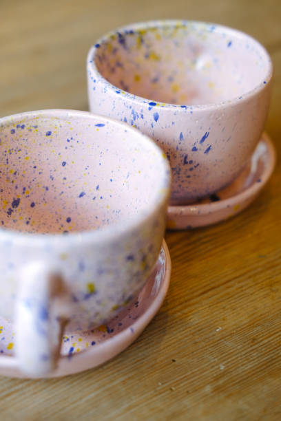 istock Ceramic cups on a pink saucer on a wooden table 1369811051
