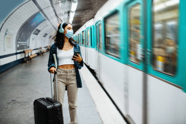 giovane viaggiatore economico che si gode una vacanza in città a parigi in estate e indossa una maschera protettiva per il viso - french metro foto e immagini stock