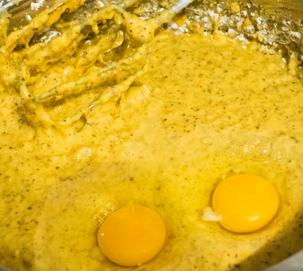 raw eggs in fresh dough - cake making mixing eggs imagens e fotografias de stock