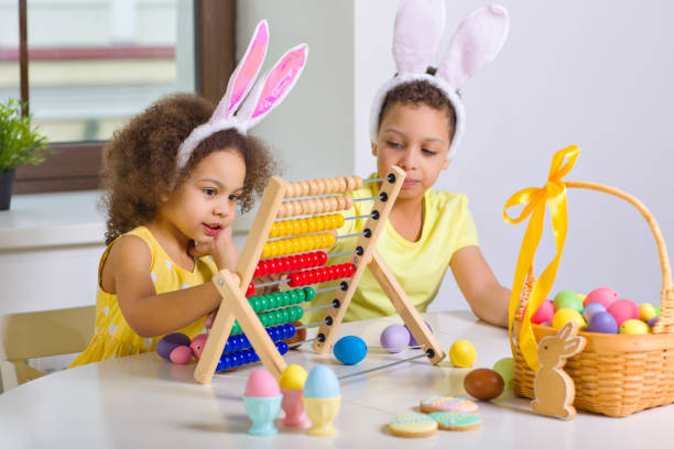 istock A Black African-American boy and his sister keep count of colored eggs, during the Easter holiday. 1369813051