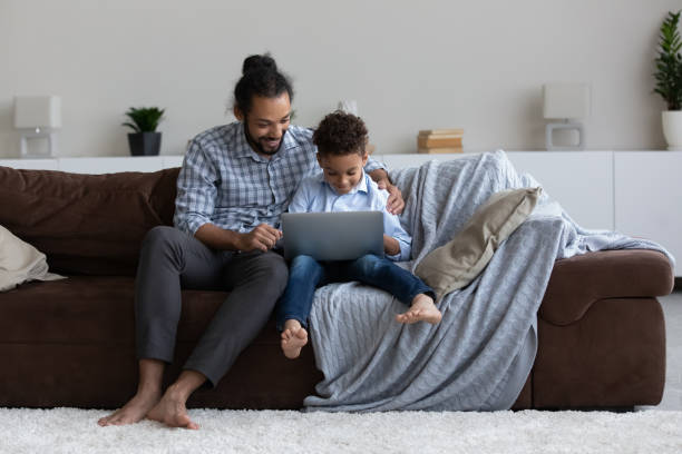 istock Happy gen Z kid and dad doing school homework together 1369813909