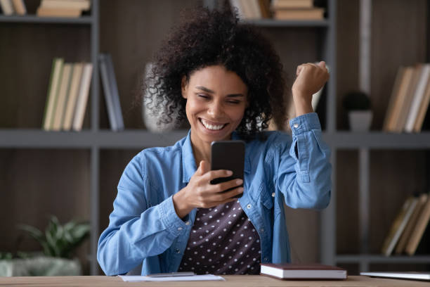 istock Happy joyful smartphone user excited with good news 1369814265