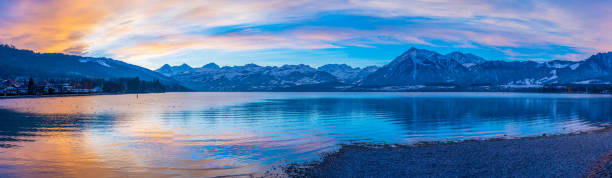 Lake Thun Panorama Lake with mountains in the morning lake thun stock pictures, royalty-free photos & images