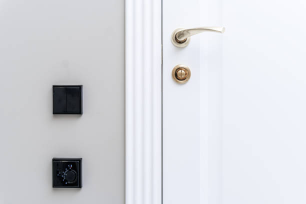 istock Stylish bronze door handle and lock on a white new interior door 1369823564