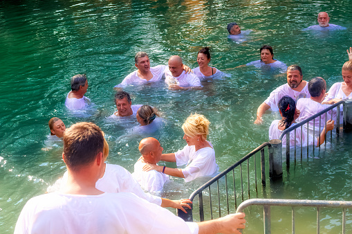 Yardenit, Israel, October 06 2018: Pilgrims during group baptism ceremony in river Jordan in Yardenit, Israel.