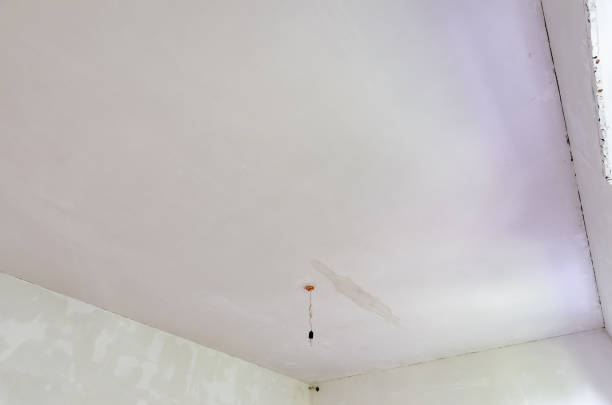 istock Plastered ceiling in the room, stains from flooding from above are visible on the ceiling 1369825024