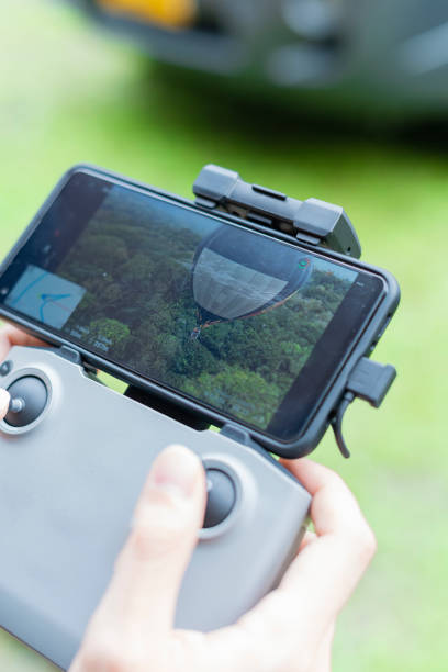 istock Man drives drone from above watching it from the screen 1369828779