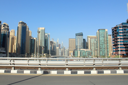 United Arab Emirates. Dubai Marina Canal. Skyscrapers in Dubai. Reinforced concrete road bridge through the canal. Landscape. Background. Spring, March, 2018.