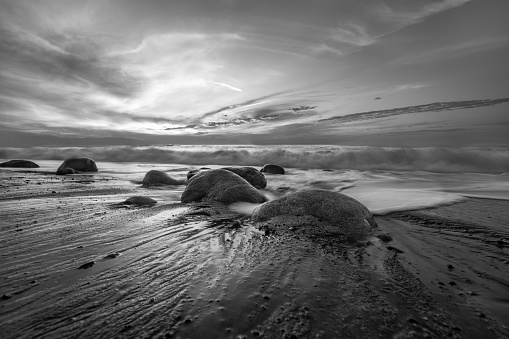 High Resolution Image Ocean Landscape With A Detailed Sand And Rock Foreground In Black And White Image Format