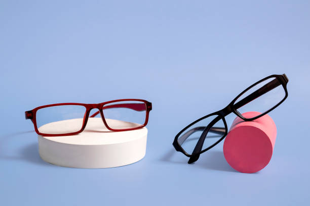 istock Classic glasses on a natural stone podium on a blue background. Optics. Closeup with copy space 1369832416