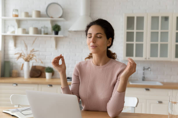 istock Calm young woman work on computer practice yoga 1369837664