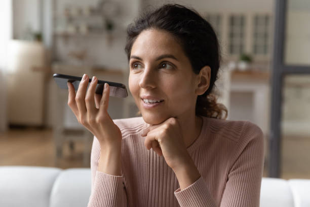 istock Young woman use modern cellphone recording audio message 1369837954