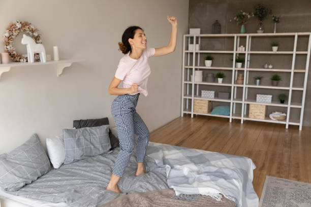 istock Happy young woman have fun dancing at home 1369837968