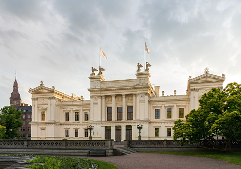 Wroclaw, Poland - June 11 2023: Beautiful and colorful Pawlowice park with a lot of beautiful trees and flowers and big and beautiful palace at center of it at sunny morning