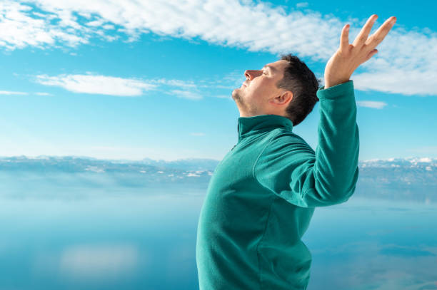istock Man on a mountain peak - expression of happiness 1369842291