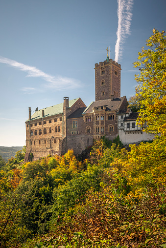 Eisenach, Germany - October 10, 2021: The Wartburg Castle at the north-west end of the Thuringian Forest under a blue sky on a beautiful day in autumn
