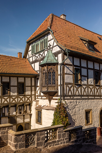 Eisenach, Germany - October 10, 2021: The Vogtei with the Nuremberg Erker on the Wartburg Castle under a blue sky on a beautiful day in autumn. In the Vogtei located is the Luther Room