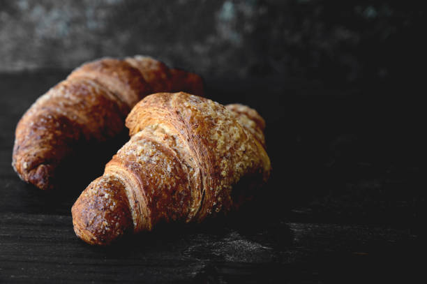 istock Fresh delicious croissant on a dark gray background 1369845830
