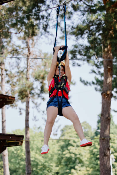 istock The girl is zip lining on sunny summer day 1369847753