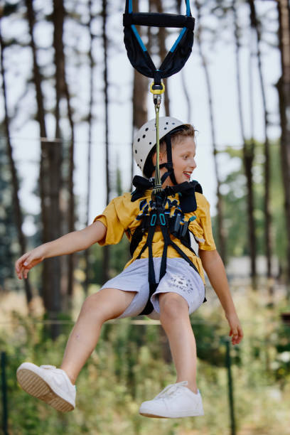 istock The boy is zip lining on sunny summer day 1369848612