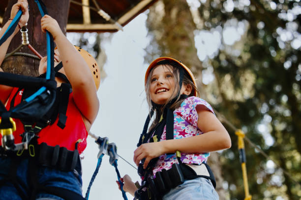 istock Happy child enjoying activity in a climbing rope park on a summer day 1369848663