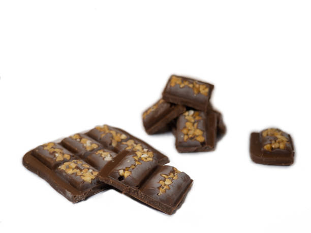 istock Milk chocolate bar with nuts on a white background.  Chocolate pyramid 1369849624