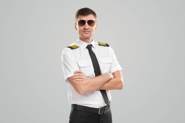 Self assured pilot in uniform and sunglasses stock photo
