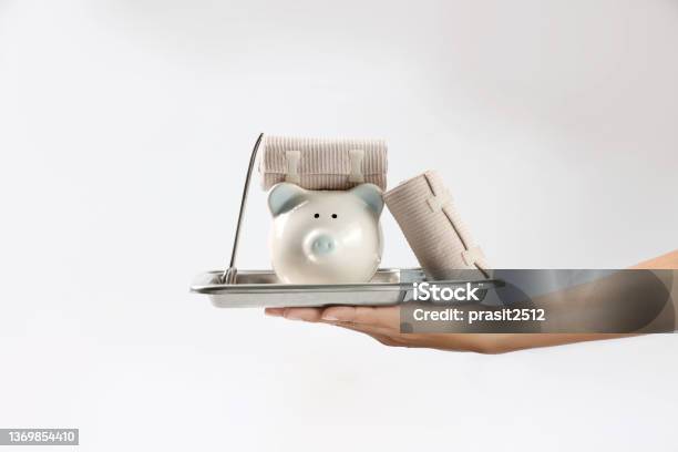 Hand With First Aid Supplies Piggy Bank Money Saving Concept Health Insurance And Family Accident Protection Stock Photo - Download Image Now